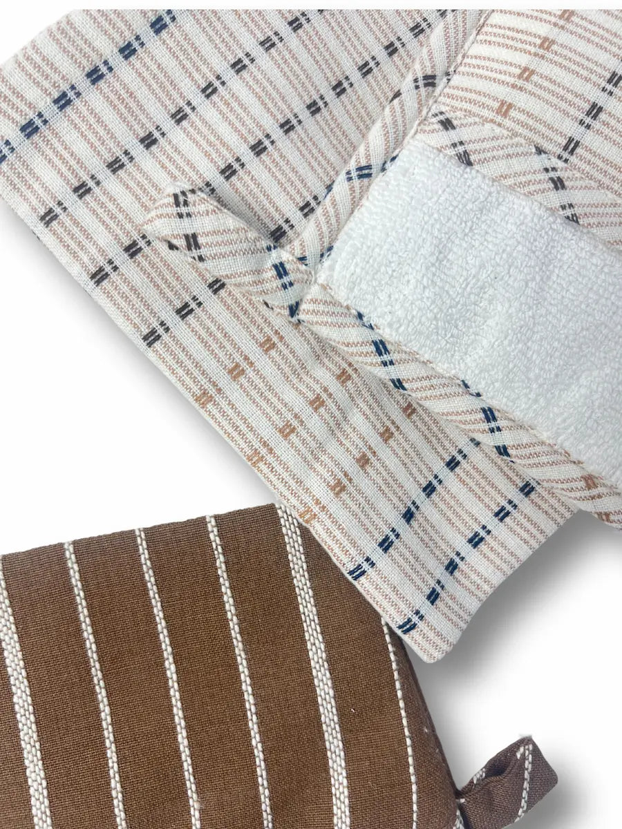 Close-up of a woven textile product, likely a pouch or sleeve, showing a cream and tan plaid pattern with thin dark blue lines, a white textured insert, and a brown section with white vertical stripes.